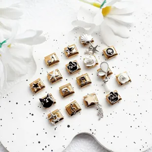 Detailed close-up of golden Italian charm bracelet links featuring floral and music motifs