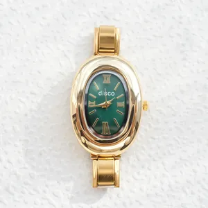 Elegant gold oval quartz watch with emerald green dial and Roman numeral markers