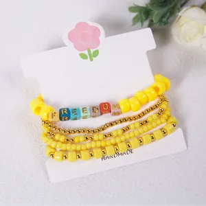 Bohemian style yellow beaded bracelet set with Freedom letter charms and heart detail