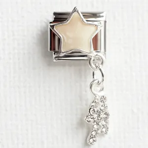 Macro shot of stainless steel Italian charm with glittery star and zircon paving pendant