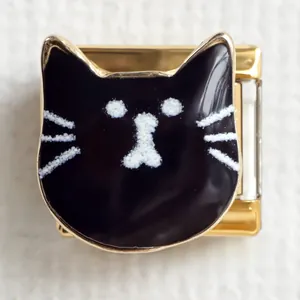 Macro view of modular Italian charm with a black enamel cat design on gold stainless steel