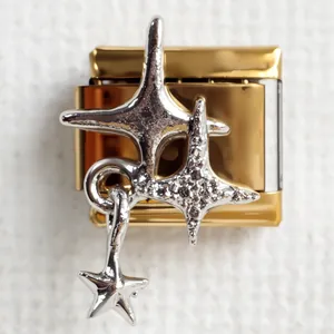 Macro view of gold Italian charm link with textured silver sea stars and star pendant