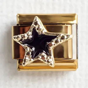 Macro detail of gold-plated star charm with black enamel for Italian modular bracelets