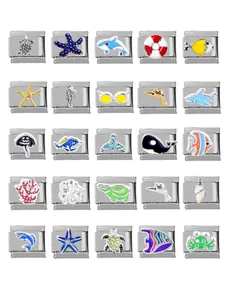 Macro display of 25 ocean-themed Italian charm links with marine life enamel designs
