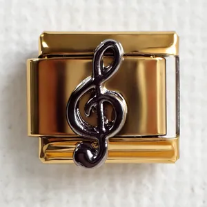 Detailed macro view of a gold Italian charm featuring a black treble clef music symbol