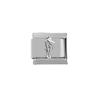 Macro detail of 304 stainless steel Italian charm link with embossed seahorse design