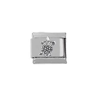 Macro detail of stainless steel Italian charm link featuring a 3D sea turtle design