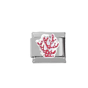 Close-up of a 304 stainless steel Italian charm featuring a red coral and white enamel