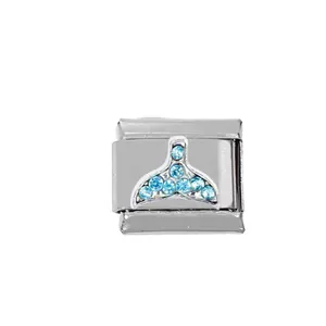 Detailed macro of Italian charm link featuring a blue crystal whale tail in stainless steel