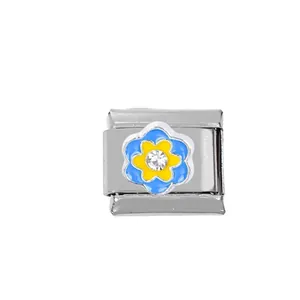 Detailed view of Italian charm link with blue and yellow oil-drop flower and crystal