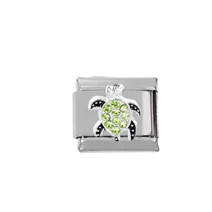 Detailed macro view of a 304 stainless steel Italian charm with a green crystal turtle