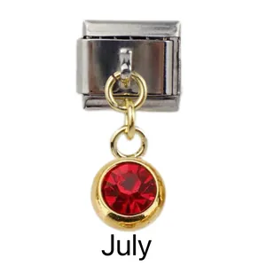 Detail of Italian modular charm for July featuring a red birthstone and golden loop