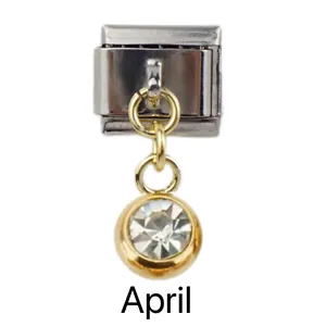 Detailed view of April birthstone Italian charm with gold pendant and clear crystal