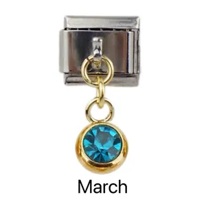Macro view of March birthstone charm in gold and silver for Italian modular bracelets