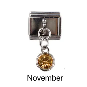 Detailed shot of November birthstone charm with amber gem for modular link bracelet