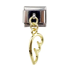 Macro detail of Italian charm bracelet link with gold wing pendant on steel base