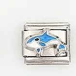 Macro shot of stainless steel Italian charm with blue enamel orca and whale pattern