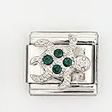 Close-up of silver Italian charm link with green rhinestone sea turtle design