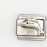 Detailed macro view of a silver Italian charm link featuring a raised dolphin relief design