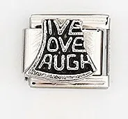 Macro shot of stainless steel Italian charm with engraved Live Love Laugh phrase