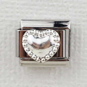 Macro detail of Italian heart charm link with embossed silver center and beaded border