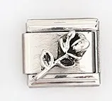 Detail of silver Italian charm with 3D rose engraving on brushed metal finish