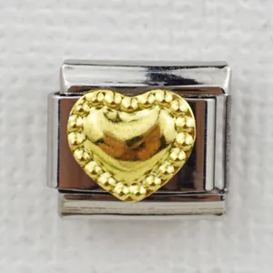 Detailed macro shot of an Italian charm bracelet link with a 3D gold heart design