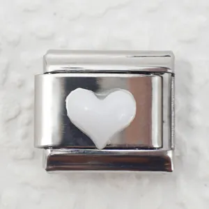 Close-up of Italian charm link with white heart detail on polished stainless steel base