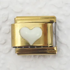 Macro shot of Italian charm link featuring a white heart set on a polished gold base