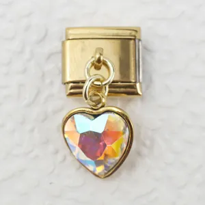 Macro shot of an Italian charm link with golden base and iridescent AB heart crystal