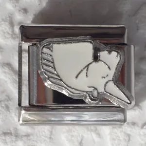 Macro detail of Italian charm bead in 304 stainless steel with whale enamel inlay