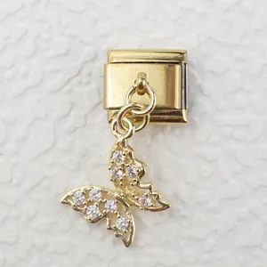 Detailed view of Italian style gold bracelet charm with a crystal-encrusted butterfly