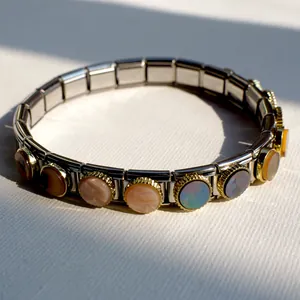 Macro view of modular Italian charm bracelet with multi-colored shell inlays