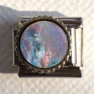 Macro shot of Italian charm link featuring holographic round inlay and gear-edge detail