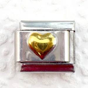 Macro shot of 9mm stainless steel modular charm with raised gold heart detail