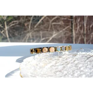 Macro shot of Italian modular bracelet with colorful round mother of pearl shell inlays