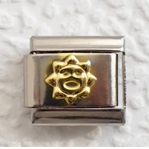 Macro detail of 9mm stainless steel charm link with gold sun face relief carving