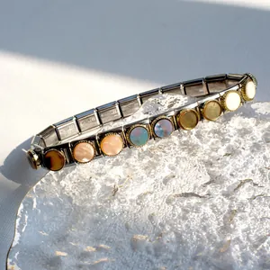 Detail of Italian modular stainless steel bracelet with 11 colorful round shell inlays