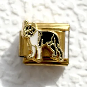 Detail of Italian charm bracelet link with black and white enamel dog charm in gold