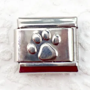 Detailed macro view of 9mm stainless steel Italian charm with embossed silver paw print