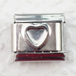 Macro shot of a 9mm stainless steel Italian charm link with a raised heart relief design