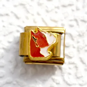 Detail of Italian modular bracelet charm with red enamel bulldog portrait in gold finish