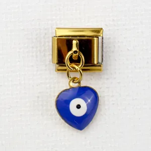 Detail of Italian gold charm link featuring a blue enamel heart and evil eye symbol