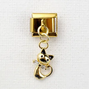 Macro shot of gold-tone Italian charm bracelet link with a diamond-studded cat pendant