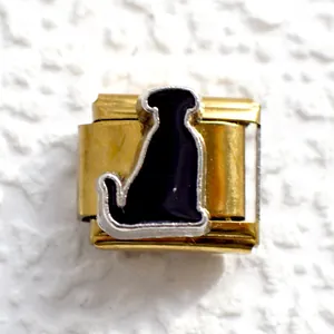 Macro view of a gold Italian charm link featuring a black dog silhouette and silver border