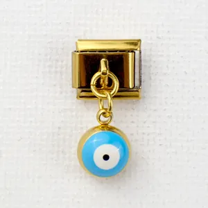 Detail of Italian style gold-plated charm featuring a blue evil eye bead on modular link