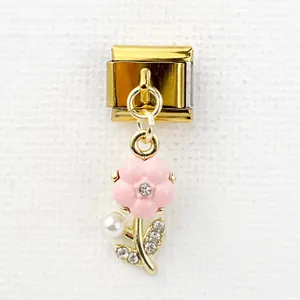Italian modular charm featuring a pink enamel flower and pearl dangle in gold finish