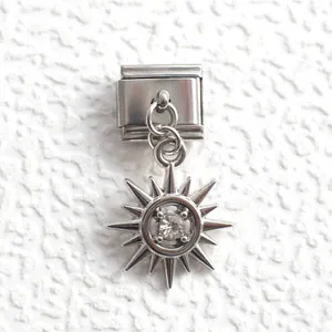 Detail view of Italian charm link featuring a silver sun pendant with a clear zircon stone