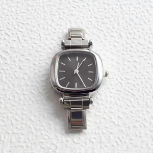 Macro shot of silver rectangular quartz watch with sleek minimalist sunburst dial