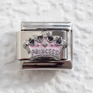 Macro view of silver crown charm with pink enamel and Princess engraving for DIY bracelets